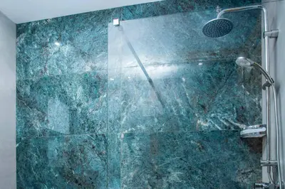 a bathroom with a shower with a glass door at Villa Karma Lindos in Líndos