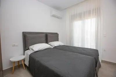 a bedroom with a large bed and a window at SoL Apt Faliraki in Faliraki