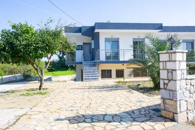 a house with a stone driveway in front of it at SoL Apt Faliraki in Faliraki