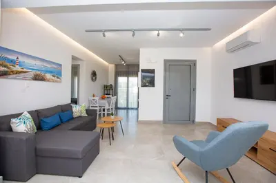 a living room with a couch and a table at SoL Apt Faliraki in Faliraki