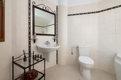 a bathroom with a toilet and a sink and a mirror at Villa Annatoli in Koskinou