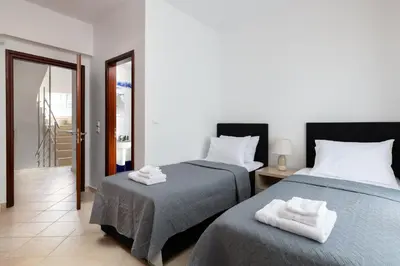a bedroom with two beds with towels on them at Villa Annatoli in Koskinou