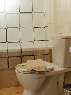 a bathroom with a toilet with a towel on it at Angels beach house in Rhodes Town