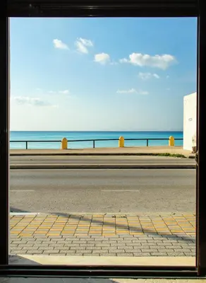 a view of a road with the ocean in the background at Angels beach house in Rhodes Town