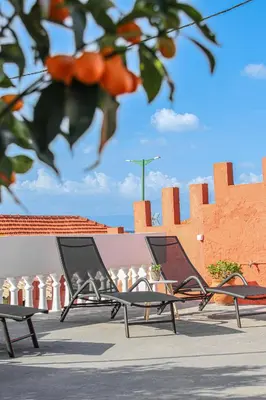 two empty chairs sitting in front of a building at Angels beach house in Rhodes Town