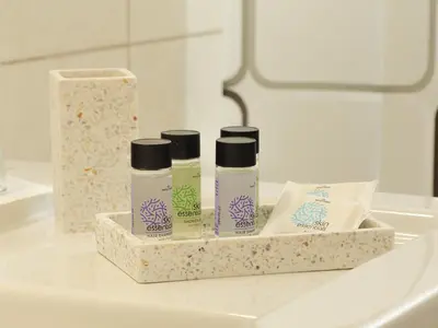 a bathroom counter with three bottles of cosmetics on it at Angels beach house in Rhodes Town