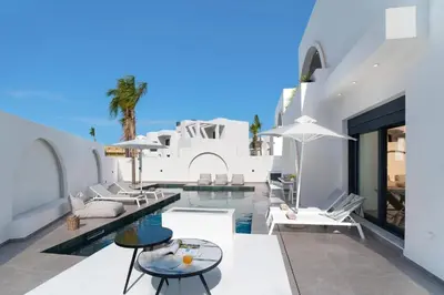 a villa with a swimming pool and a resort at Villa Palmeras Evelia by Villa Plus in Ialyssos