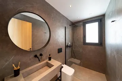 a bathroom with a sink and a mirror at Villa Palmeras Evelia by Villa Plus in Ialyssos
