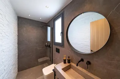 a bathroom with a sink and a mirror at Villa Palmeras Evelia by Villa Plus in Ialyssos
