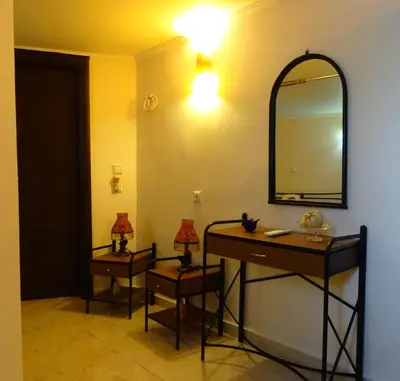 a bathroom with a vanity and a mirror on a wall at Nadia's House 2 in Afantou