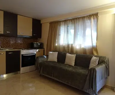 a living room with a couch in front of a window at Nadia's House 2 in Afantou