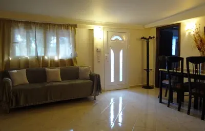 a living room with a couch and a door at Nadia's House 2 in Afantou