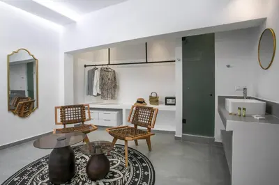 a living room with two chairs and a table at Calma Luxury Studios & Suites in Faliraki