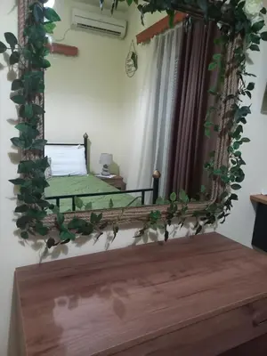 a mirror with a bed in a room at Maria's garden house in Archangelos