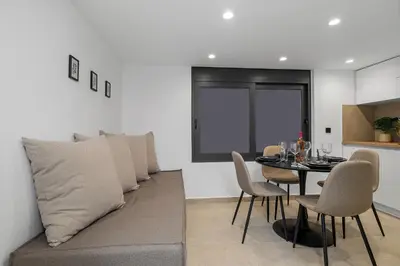 a dining room with a couch and a table at San Marino Luxury Suites #2 in Asgourou