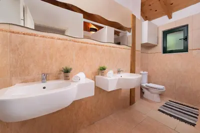 a bathroom with a white sink and a toilet at 4 BD Luxurious villa with swimming pool in Sálakos