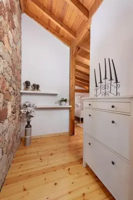 a room with a dresser and a brick wall at 4 BD Luxurious villa with swimming pool in Sálakos