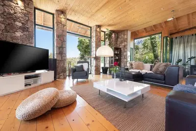 a living room with a tv and a couch and a table at 4 BD Luxurious villa with swimming pool in Sálakos