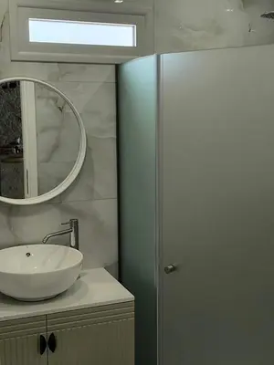 a bathroom with a sink and a mirror at Valantina's & Mannouel Lardos Luxury Villas in Lardos