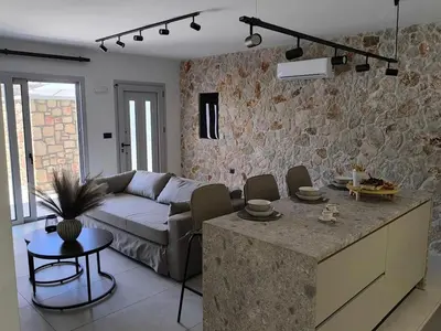 a living room with a couch and a table at Valantina's & Mannouel Lardos Luxury Villas in Lardos