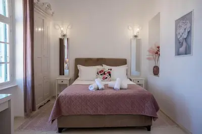 a bedroom with a bed with two teddy bears on it at 