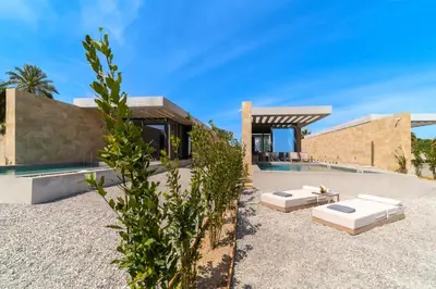a backyard of a house with a swimming pool at Linear Cabanon Kallithea Luxury Villas in Koskinou