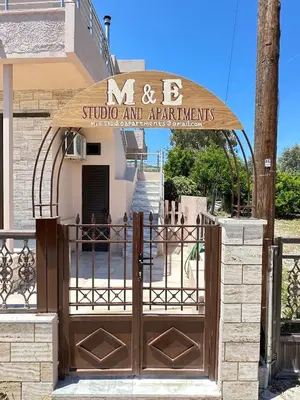 an entrance to a building with a wooden gate at M&E APARTMENTS New in Haraki
