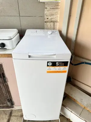 a white refrigerator sitting inside of a room at M&E APARTMENTS New in Haraki