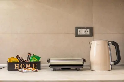 a coffee maker sitting on a counter next to a home appliance at M&E APARTMENTS New in Haraki