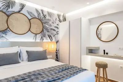 a bedroom with a bed and mirrors on the wall at Villa Levanta in Gennadi