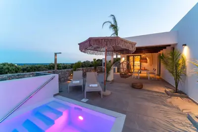 a house with a swimming pool and an umbrella at Villa Levanta in Gennadi
