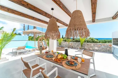 a dining room with a table with food on it at Villa Levanta in Gennadi
