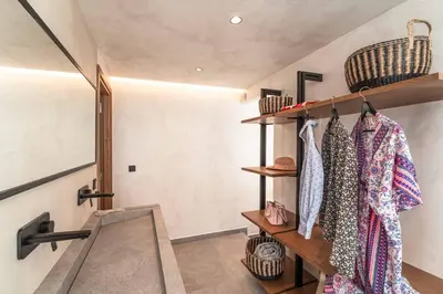 a room with shelves and a closet with clothes at Villa Helios in Kiotari