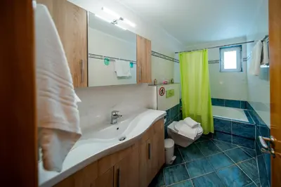 a bathroom with a sink and a tub and a shower at Katerina Apartment in Afantou