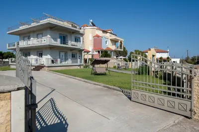 a house with a gate in front of a yard at Katerina Apartment in Afantou