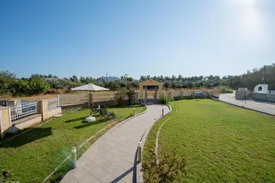 a park with a walkway and a grass field at Katerina Apartment in Afantou