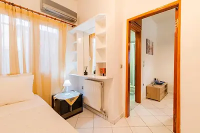 a bedroom with a bed and a mirror at Louis House in Rhodes Town