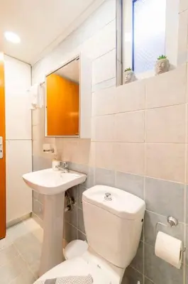 a bathroom with a toilet and a sink at Louis House in Rhodes Town