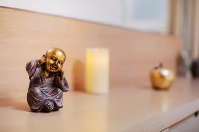 a small figurine of a person sitting on a table at Louis House in Rhodes Town