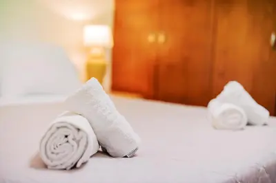 two towels sitting on top of a bed at Louis House in Rhodes Town