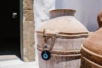 a large wooden vase with a blue button on it at 1919's Studio in Asklipiḯon