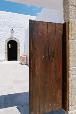 a wooden door on the side of a building at 1919's Studio in Asklipiḯon