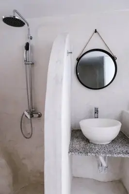 a white bathroom with a sink and a mirror at 1919's Studio in Asklipiḯon