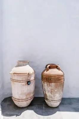 two large vases sitting next to a wall at 1919's Studio in Asklipiḯon