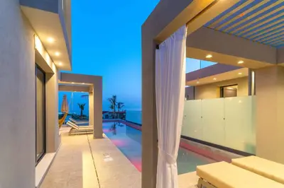 a house with a swimming pool and a house at Villa Ouranos in Kiotari