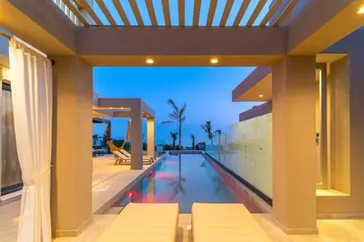 a swimming pool in the middle of a house at Villa Ouranos in Kiotari