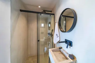 a bathroom with a shower and a mirror at Villa Ouranos in Kiotari