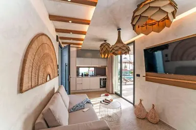 a living room with a couch and a tv at Villa Ouranos in Kiotari