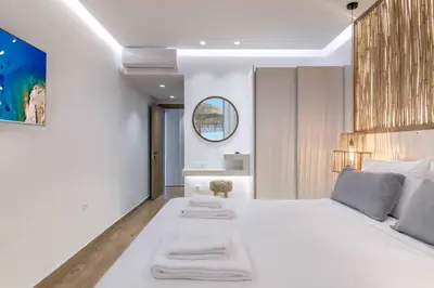 a bedroom with a large white bed with towels on it at Villa Elia Gennadi in Gennadi