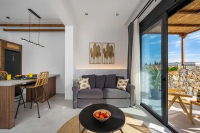 a living room with a couch and a table at Villa Kiotari Sky in Kiotari